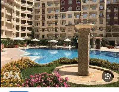 a large swimming pool in front of a large building at كمبوند فلورنز in Hurghada