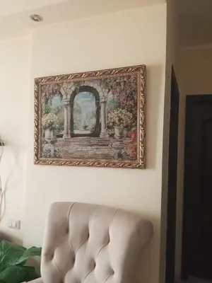 a picture hanging on a wall next to a couch at كمبوند فلورنز in Hurghada