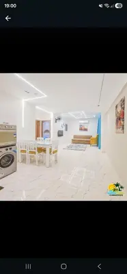 a large living room with a table and a kitchen at Princess tala in Hurghada