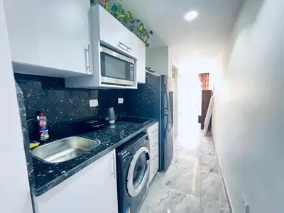 a kitchen with a sink and a washing machine at One bedroom and reception in Hurghada