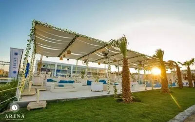 a group of tables and chairs under a pavilion at One bedroom and reception in Hurghada