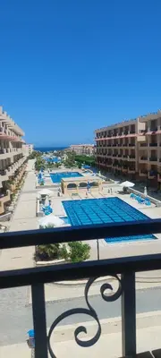 a view of a pool from a balcony of a resort at One bedroom and reception in Hurghada