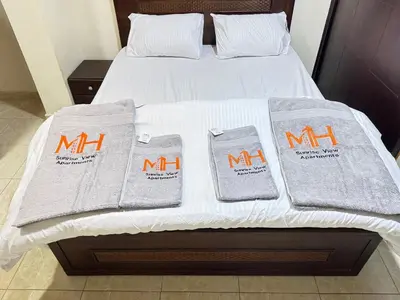 a bed with white blankets and towels on it at Safaga SeaView Rooftop in Safaga