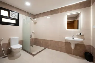 a bathroom with a toilet and a sink at Elyasmene in Qena