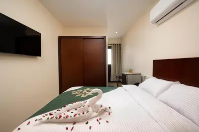 a bedroom with a swan decoration on a bed at Elyasmene in Qena