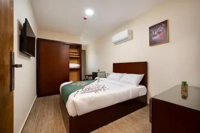 a bedroom with a bed and a television in it at Elyasmene in Qena