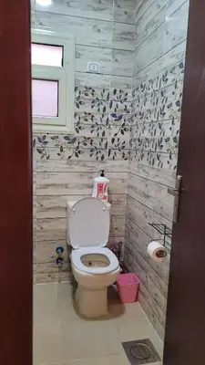 a bathroom with a toilet and a window at Casablanca star hurghada in Hurghada
