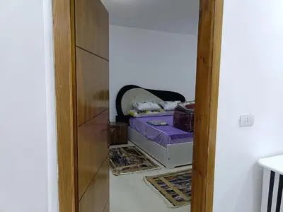 a hallway with a purple bed in a room at شقة كاملة بغرفتي نوم دور ارضي in Hurghada