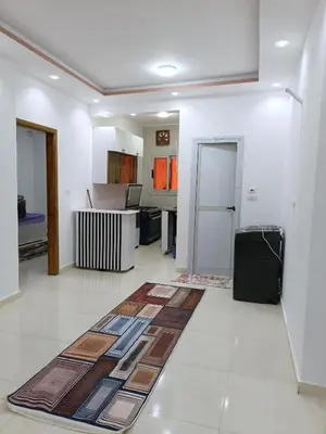 a room with a kitchen with a rug on the floor at شقة كاملة بغرفتي نوم دور ارضي in Hurghada
