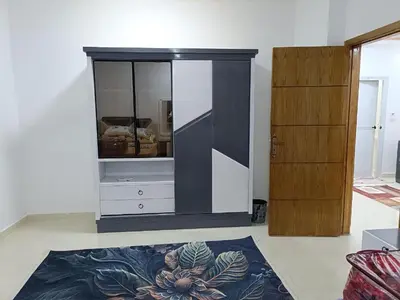 a living room with a cabinet and a rug at شقة كاملة بغرفتي نوم دور ارضي in Hurghada