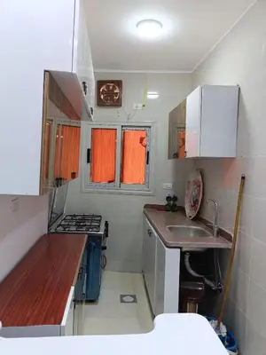 a small kitchen with a sink and a stove at شقة كاملة بغرفتي نوم دور ارضي in Hurghada