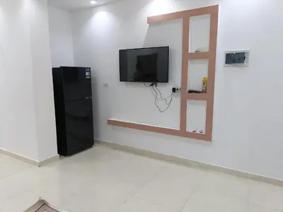 a room with a flat screen tv on a wall at شقة كاملة بغرفتي نوم دور ارضي in Hurghada