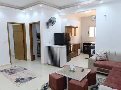 a living room with a couch and a table at شقة كاملة بغرفتي نوم in Hurghada