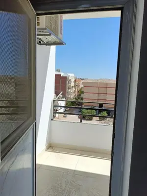 a view from an open window of a balcony at شقة كاملة بغرفتي نوم in Hurghada