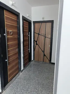 a hallway with two wooden doors in a room at شقة كاملة بغرفتي نوم in Hurghada