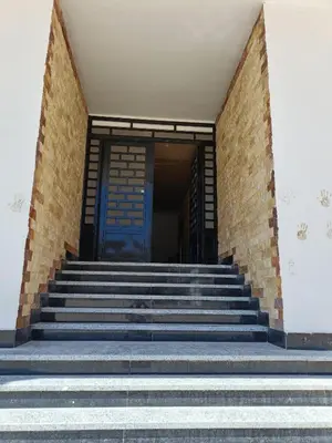 a set of stairs in front of a building with a blue door at شقة كاملة بغرفتي نوم in Hurghada