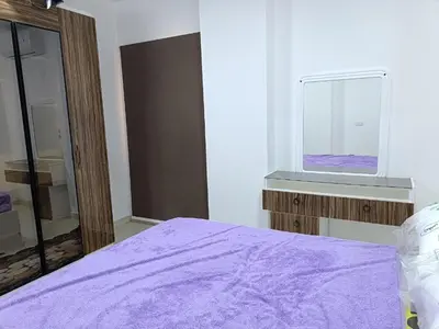 a bedroom with a purple bed and a window at شقة كاملة بغرفتي نوم in Hurghada