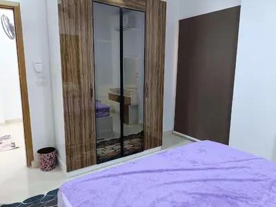 a bedroom with a mirror and a purple bed at شقة كاملة بغرفتي نوم in Hurghada