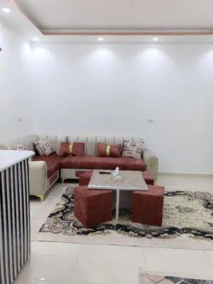 a living room with a couch and a table at شقة كاملة بغرفتي نوم in Hurghada