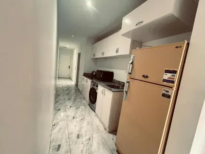 a small kitchen with a refrigerator and a sink at Selena Bay in Hurghada