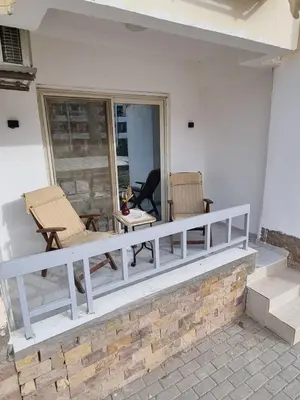 a porch with two chairs and a table at شقه على البحر مباشره in Hurghada