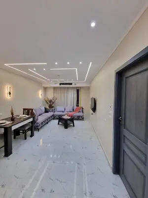 a living room with couches and a table at شقه على البحر مباشره in Hurghada