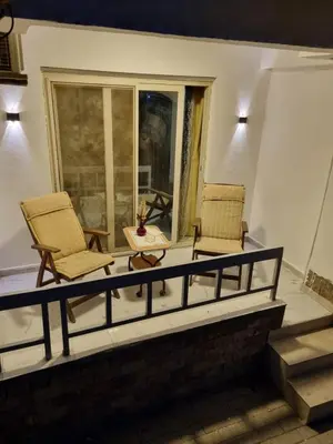 two chairs and a table on a balcony at شقه على البحر مباشره in Hurghada