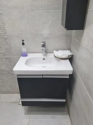 a bathroom sink with a soap bottle on it at شقه على البحر مباشره in Hurghada