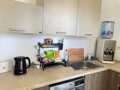 a kitchen counter with a sink and a microwave at 2BR G-Cribs in Hurghada