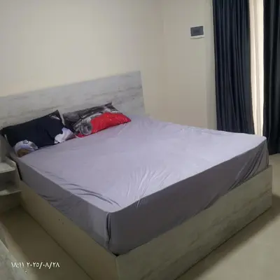 a bed with two pillows on it in a bedroom at جولدن طيبه الذهبيه in Hurghada