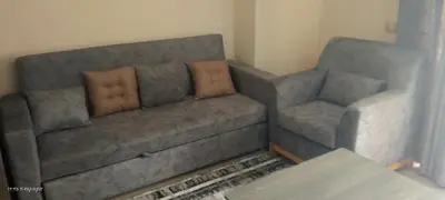 a living room with a couch and a chair at جولدن طيبه الذهبيه in Hurghada