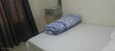a bed with a blue and white blanket on it at جولدن طيبه الذهبيه in Hurghada
