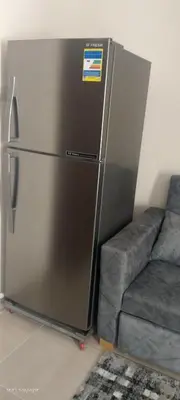 a refrigerator in a room next to a couch at جولدن طيبه الذهبيه in Hurghada