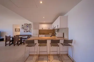 an open kitchen and dining room with white cabinets at Luxury Stays in New Marina El Gouna in Hurghada