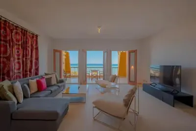 a living room with a couch and a television at Luxury Stays in New Marina El Gouna in Hurghada
