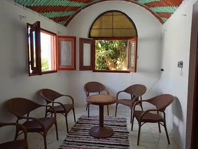 a room with chairs and a table and a window at Reagan House in Aswan