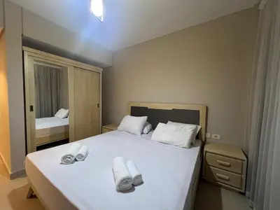 a bedroom with a bed with white towels on it at Beachside Mangroovy 1BR in Hurghada