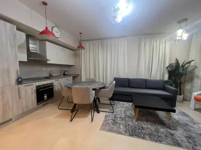 a living room with a couch and a table at Beachside Mangroovy 1BR in Hurghada