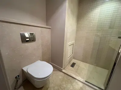 a bathroom with a toilet and a shower at Beachside Mangroovy 1BR in Hurghada