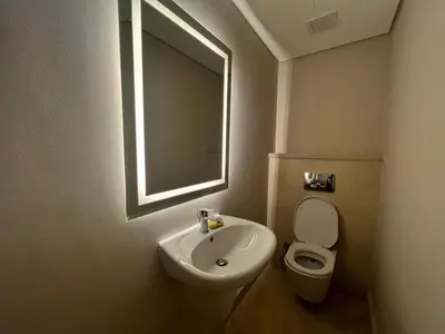 a bathroom with a sink and a toilet and a mirror at Beachside Mangroovy 1BR in Hurghada