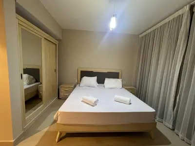a bedroom with a bed with two towels on it at Beachside Mangroovy 1BR in Hurghada