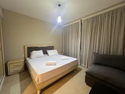 a bedroom with a bed with two towels on it at Beachside Mangroovy 1BR in Hurghada