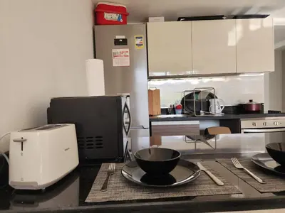 a kitchen with a mixer and a bowl on a counter at El Gouna Poolfront Cozy Stay 2BR in Hurghada