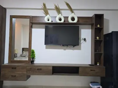a entertainment center with a tv and a mirror at Golden Tiba in Hurghada