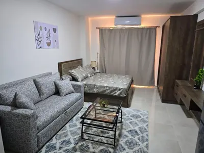 a living room with a couch and a table at Golden Tiba in Hurghada