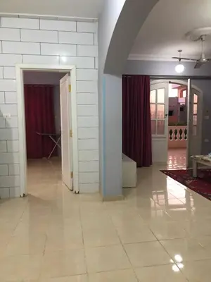 a living room with a tile floor and white walls at Ozera villa - west bank in Luxor