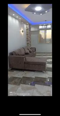 a living room with two couches and a blue ceiling at Dream Apartment 4 in Hurghada