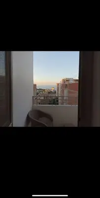 a bathroom with a toilet and a view of a city at Dream Apartment 4 in Hurghada