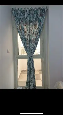 a window with a curtain in a room at Dream Apartment 4 in Hurghada
