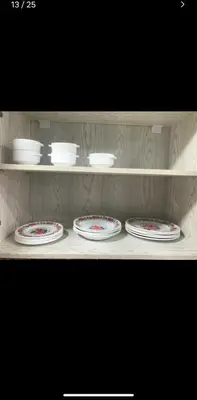 a shelf with four plates and bowls on it at Dream Apartment 4 in Hurghada